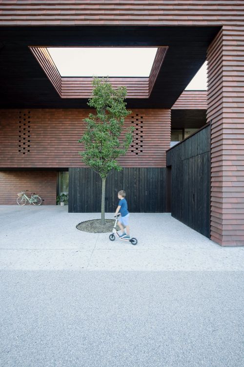 OFIS Arhitekti clads geometric home in Slovenia with red-brick t