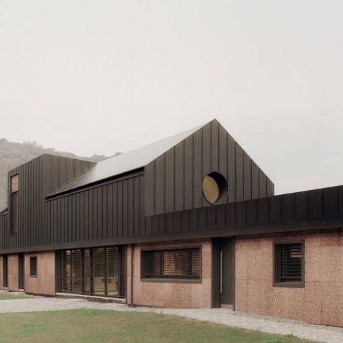 LCA Architetti nestles angular cork-clad home into Italian valle